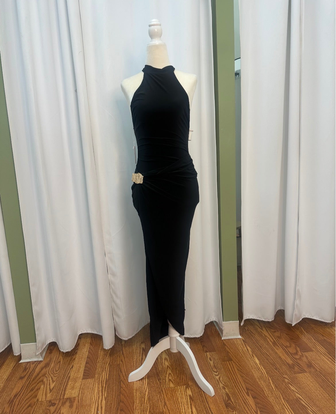 black stretch material dress, halter top, gold design on hip.